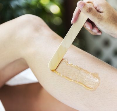 Woman getting legs waxed at a spa